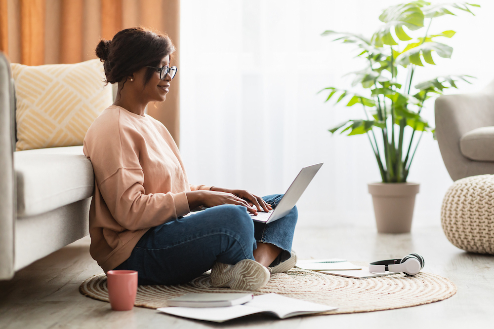 Woman Sitting on the Floor Using Her Laptop