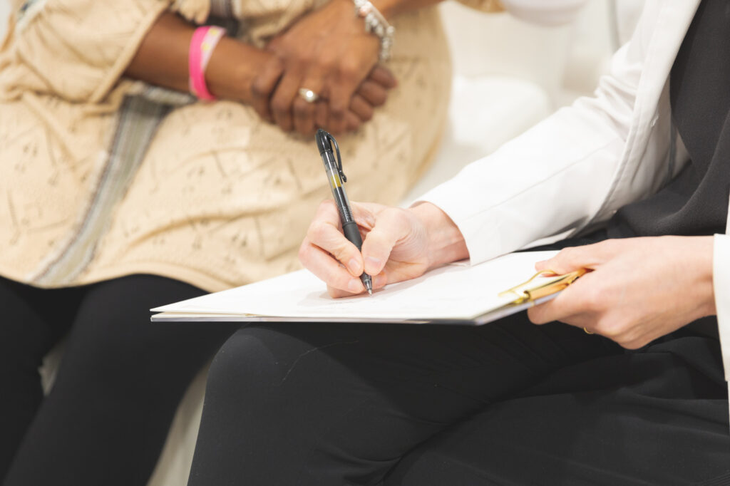 Close Up of Dr. Wallace Writing on a Clipboard